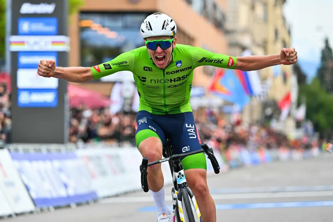 Slovenia's Tadej Pogacar celebrates as he crosses the finish line to win the men's Elite Road Race cycling event during the UCI 2024 Road World Championships, in Zurich, on Sept 29.