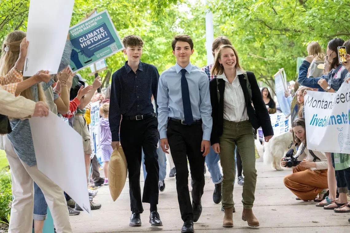 This picture provided by Our Children's Trust shows plaintiffs in the landmark Held vs Montana climate change lawsuit arrive to the Lewis and Clark County Courthouse on June 13, 2023 in Helena, Montana. In a landmark climate trial, a Montana court on August 14, 2023 ruled in favor of a group of youths who accused the western US state of violating their rights to a clean environment. District Court Judge Kathy Seeley said a state law preventing agencies from considering the impacts of greenhouse gases when issuing permits for fossil fuel development was unconstitutional. The case, Held v. State of Montana -- brought by plaintiffs ranging in age from five to 22 -- has been closely watched because it could bolster similar litigation that has been filed across the country. (Photo by Robin Loznak / Our Children's Trust / AFP) / RESTRICTED TO EDITORIAL USE - MANDATORY CREDIT "AFP PHOTO / Robin Loznak/Courtesy of Our Children's Trust" - NO MARKETING NO ADVERTISING CAMPAIGNS - DISTRIBUTED AS A SERVICE TO CLIENTS