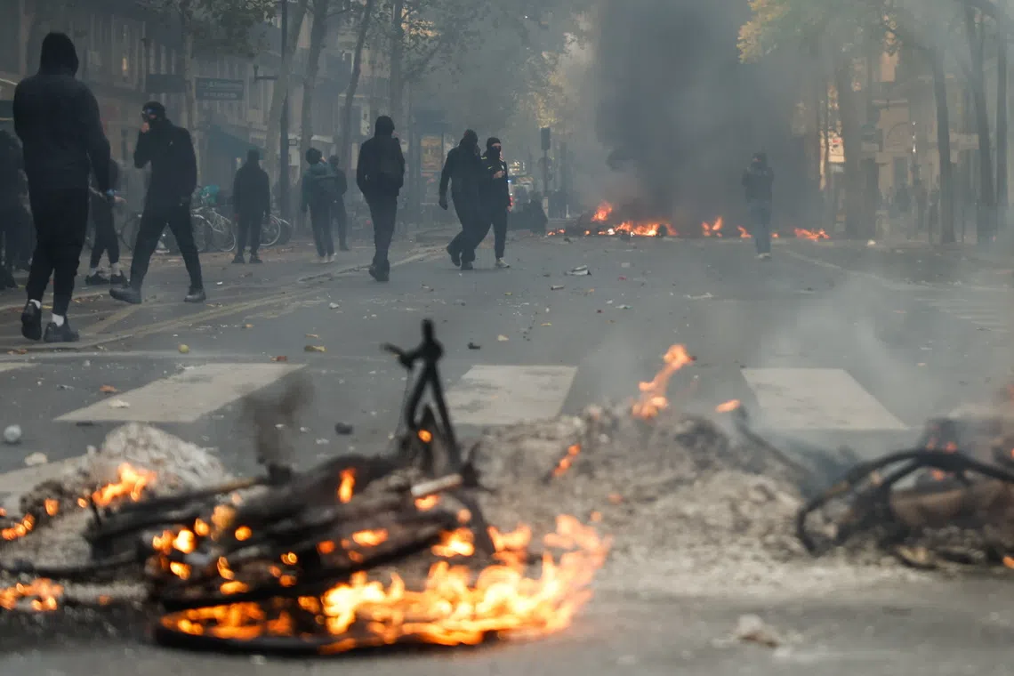 Flames and smoke rise during a demonstration against rising living costs in Paris, France, on Oct 17.
