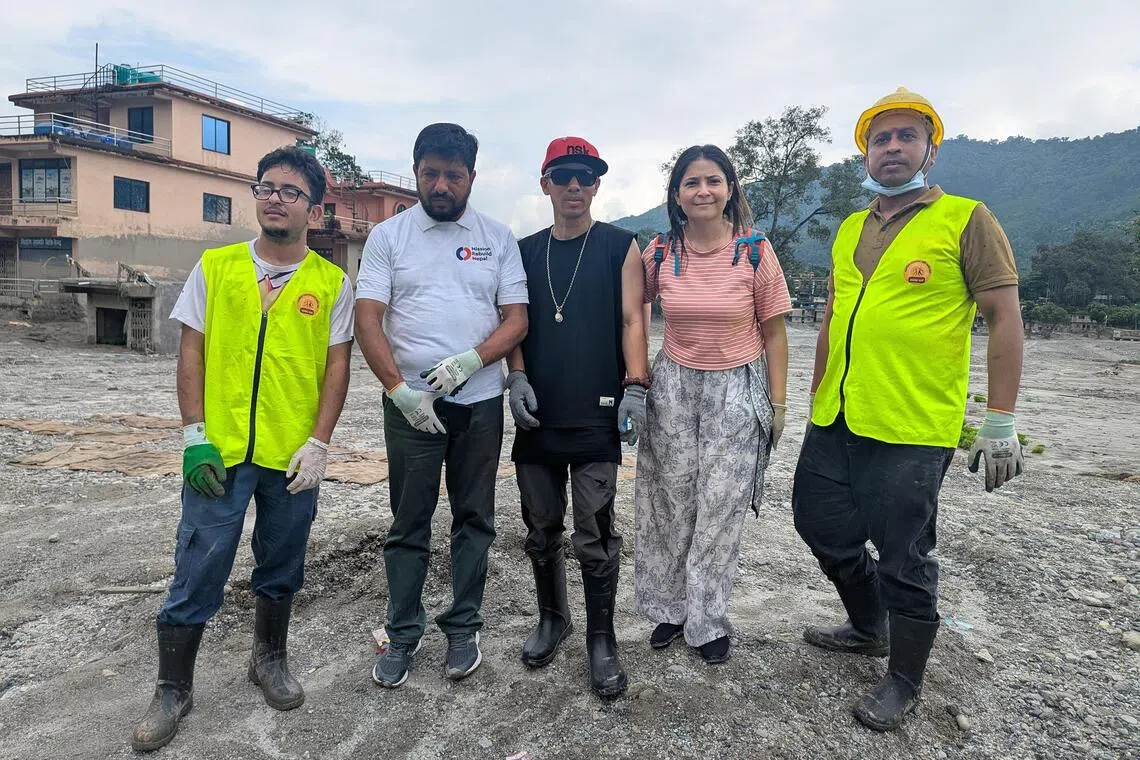 Rapper Nirnaya Shreshta (in black), retired policeman CP Gautam (in white) and upcycling entrepreneur Prakriti Mainali gathered 80 volunteers from Kathmandu to clear silt from flood-affected towns like Devighat in Nepal.