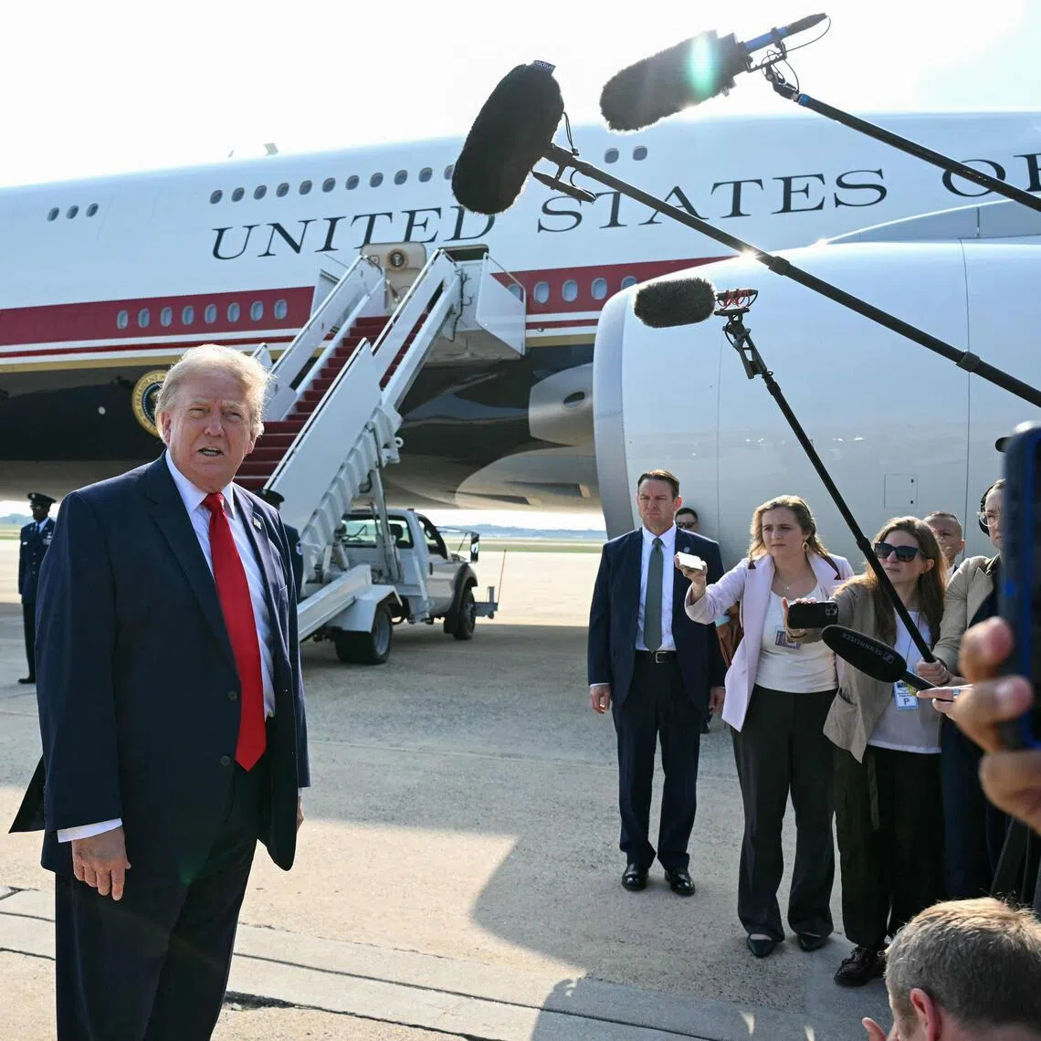 TOPSHOT - US President Donald Trump speaks to the press before he boards Air Force One for his first flight aboard the Boeing 747-8 that Qatar gifted the United States to use for executive travel, at Joint Base Andrews, in Maryland, July 1, 2026. President Trump is traveling to Medora, North Dakota to participate in the Theodore Roosevelt Presidential Library Opening Ceremony. (Photo by SAUL LOEB / AFP)