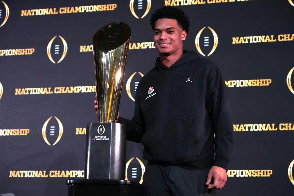 FILE PHOTO: Jan 9, 2024; Houston, TX, USA; Michigan Wolverines cornerback Will Johnson poses with College Football National Championship trophy at press conference at JW Marriot Houston by the Galleria. Mandatory Credit: Kirby Lee-USA TODAY Sports/File Photo