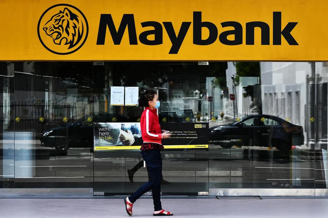 Woman wearing face mask walking past Maybank branch at Textile Centre at 1.42pm on June 9, 2020.