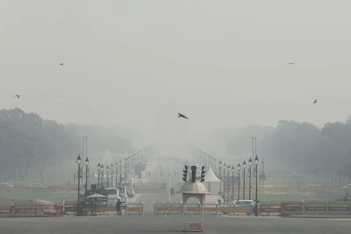 People walk on 'Kartavya Path' amidst the morning smog as air pollution levels declined in New Delhi, India, November 6, 2023.REUTERS/Anushree Fadnavis