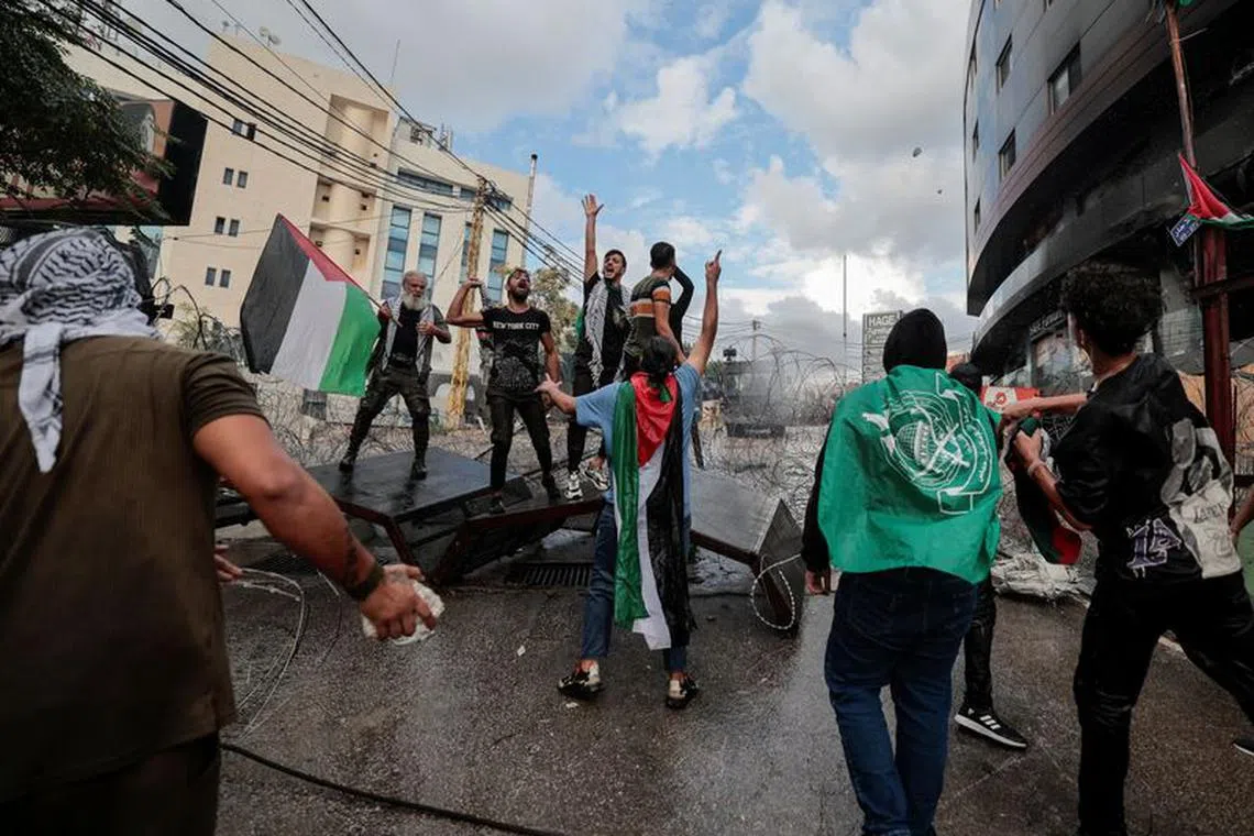 People clash with security forces during a protest near the U.S. embassy in Awkar, after hundreds of Palestinians were killed in a blast at Al-Ahli hospital in Gaza that Israeli and Palestinian officials blamed on each other, Lebanon October 18, 2023. REUTERS/Zohra Bensemra