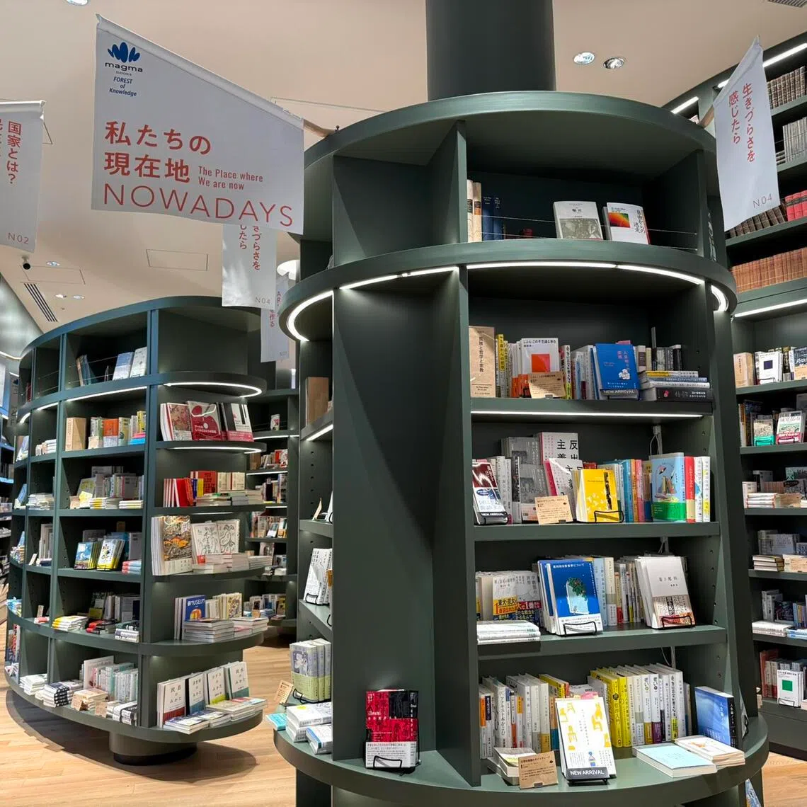 Magmabooks, which opened at the Toranomon Hills complex in April 2025, aims to bring visitors on a journey of self-discovery through books that answer philosophy questions such as (left) “What is a country? What is democracy?”.