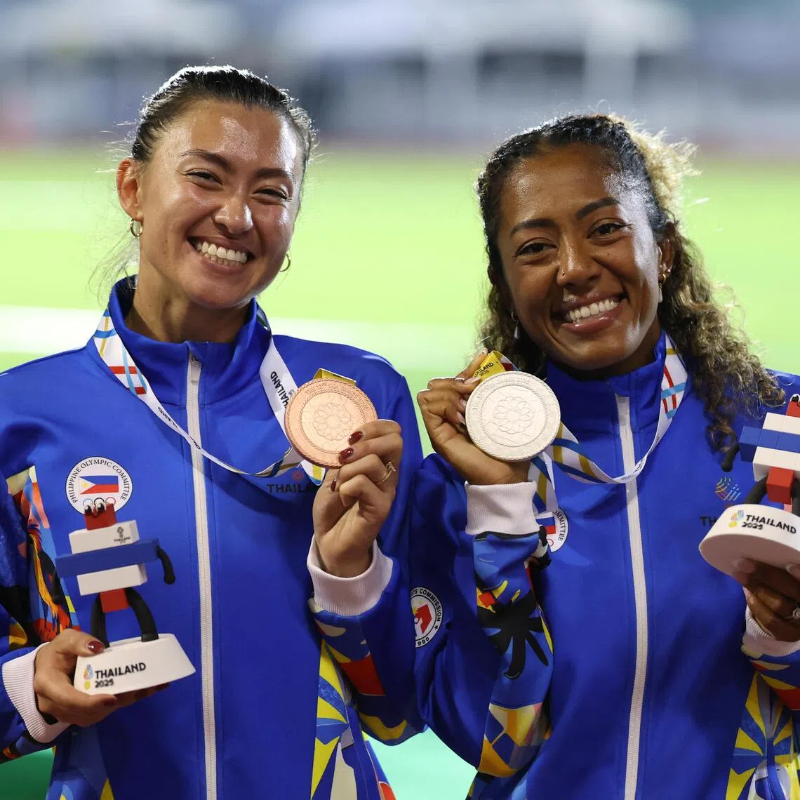 Silver medallist Philippines' Robyn Brown (right) and bronze medallists Philippines' Lauren Alexis Hoffman  celebrate on the podium during the women's 400m hurdles medal ceremony REUTERS/Patipat Janthong