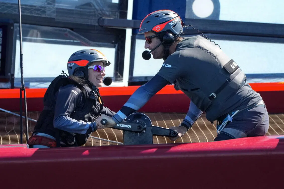 Hannah Mills (left) of Great Britain SailGP Team and Ben Ainslie, helmsman of Great Britain SailGP Team on the Great Britain SailGP Team F50 catamaran work on the grinding pedestal. Spain SailGP, Event 6, Season 2 in Cadiz, Andalucia, Spain. 8th October 2021.