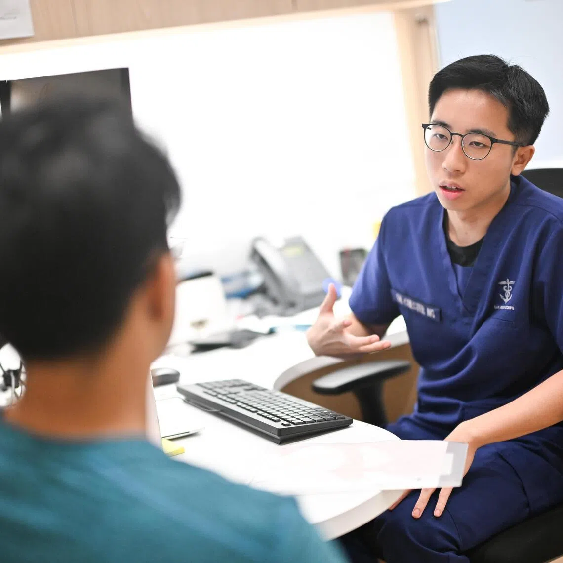 A pre-enlistee (left) seeing a Medical Officer for consultation inside the Medical Classification Centre in Central Manpower Base. 

The MCC offers a seamless omni-channel customer experience for PEs which includes mobile-friendly registration and queue system with personalised itinerary, enabled by the Integrated Queue and Registration system, and dedicated staff on standby to assist. The medical equipment is new and updated, thereby improving staff productivity and benefiting patient care.

Part of the BMT feature to look at Mindef's medical classification process and how they sort the recruits into the different PES.

(ST PHOTO: LIM YAOHUI)