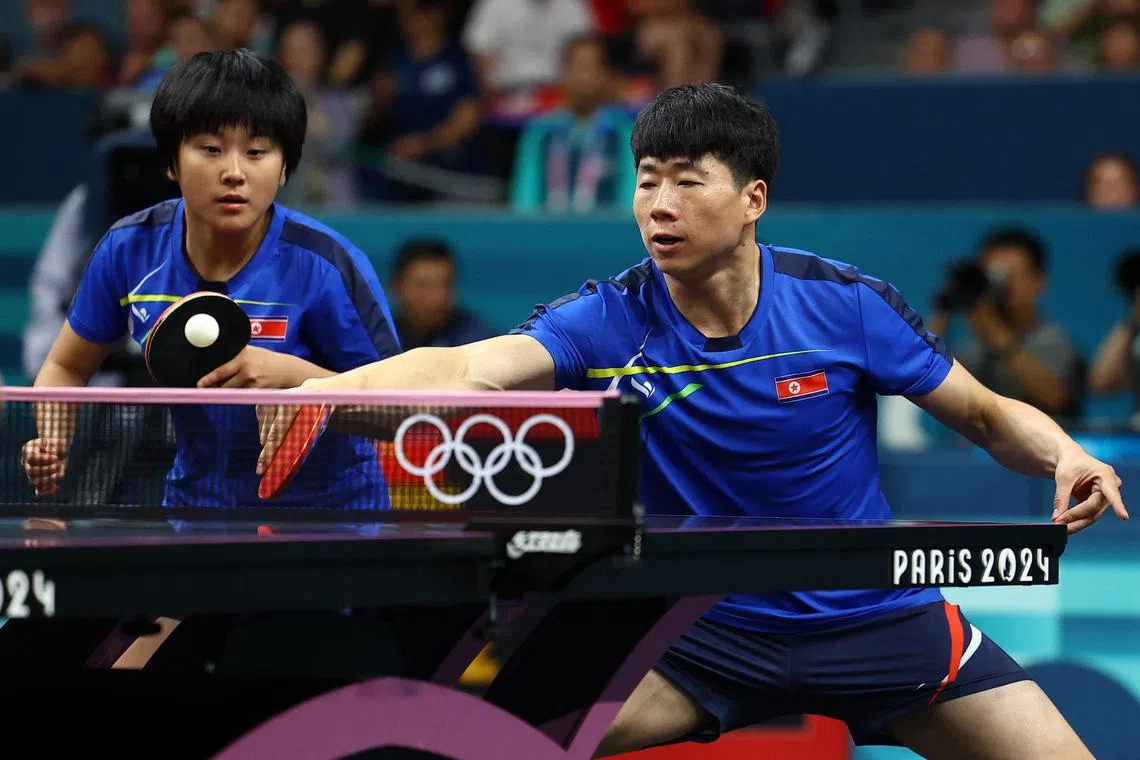Paris 2024 Olympics - Table Tennis - Mixed Doubles Gold Medal Match - South Paris Arena 4, Paris, France - July 30, 2024. Jong Sik Ri of North Korea and Kum Yong Kim of North Korea in action during their match against Chuqin Wang of China and Yingsha Sun of China. REUTERS/Kim Hong-Ji