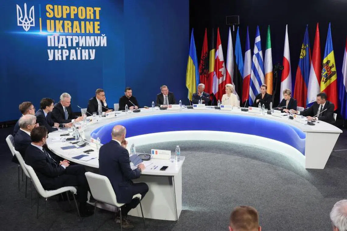 TOPSHOT - (From L of table) France’s Delegate Minister for Europe Benjamin Haddad, Sweden’s Prime Minister Ulf Kristersson, Norway’s Prime Minister Jonas Gahr Stoere, Estonia’s Prime Minister Kristen Michal, Canada’s Prime Minister Justin Trudeau, Lithuania’s President Gitanas Nauseda, Finland’s President Alexander Stubb, Ukrainian President Volodymyr Zelensky, Latvia’s President Edgars Rinkevics, European Council President Antonio Costa, European Commission President Ursula von der Leyen, Denmark’s Prime Minister Mette Frederiksen, Iceland’s Prime Minister Kristrun Frostadottir and Spain’s Prime Minister Pedro Sanchez, attend a press conference after the ‘Support Ukraine’ summit, marking the third anniversary of the Russian invasion, in Kyiv, Ukraine, on February 24, 2025. (Photo by Gleb Garanich / POOL / AFP)