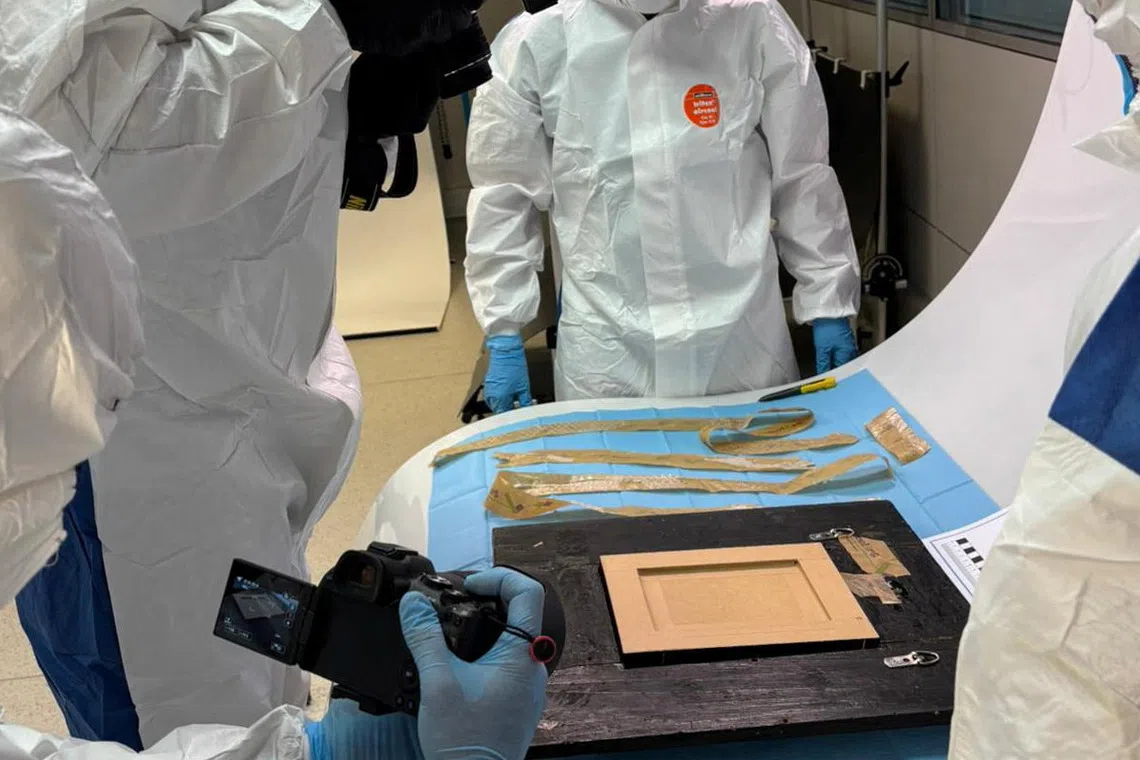 Spanish National Police inspect a Picasso painting \"Still Life with Guitar\", that disappeared during transport on October 10, 2025, in Madrid, Spain October 24, 2025. Spanish National Police/Handout via REUTERS A