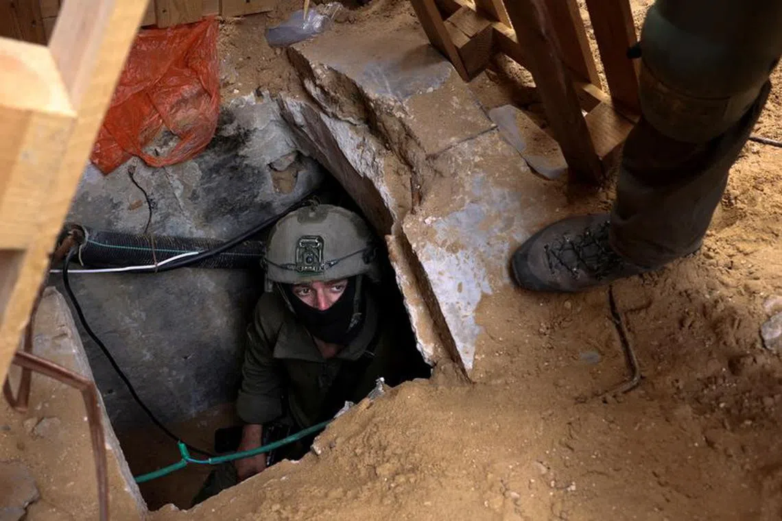 FILE PHOTO: Israeli soldiers operate at the opening to a tunnel at Al Shifa Hospital compound in Gaza City, amid the ongoing ground operation of the Israeli army against Palestinian Islamist group Hamas, in the Gaza Strip, November 22, 2023. REUTERS/Ronen Zvulun/File Photo