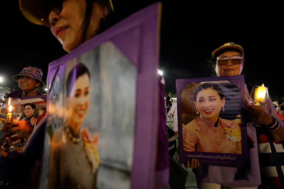 Well-wishers holding candles and portraits of Queen Suthida during her 48th birthday celebrations at Sanam Luang in Bangkok, Thailand, on June 3, 2026.