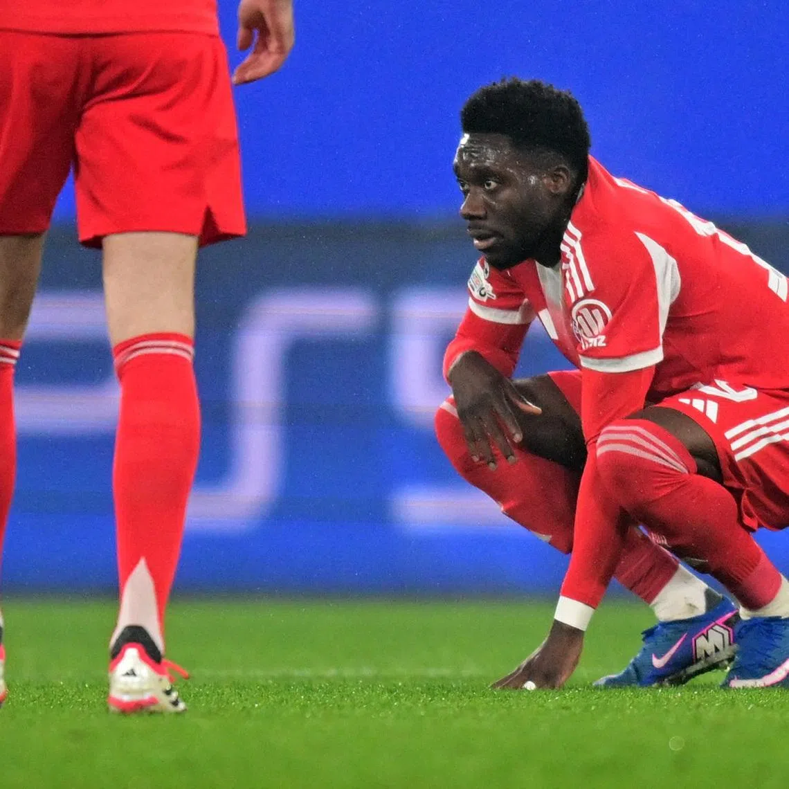 Soccer Football - UEFA Champions League - Round of 16 - First Leg - Atalanta v Bayern Munich - New Balance Arena, Bergamo, Italy - March 10, 2026 Bayern Munich's Alphonso Davies looks dejected after sustaining an injury REUTERS/Daniele Mascolo
