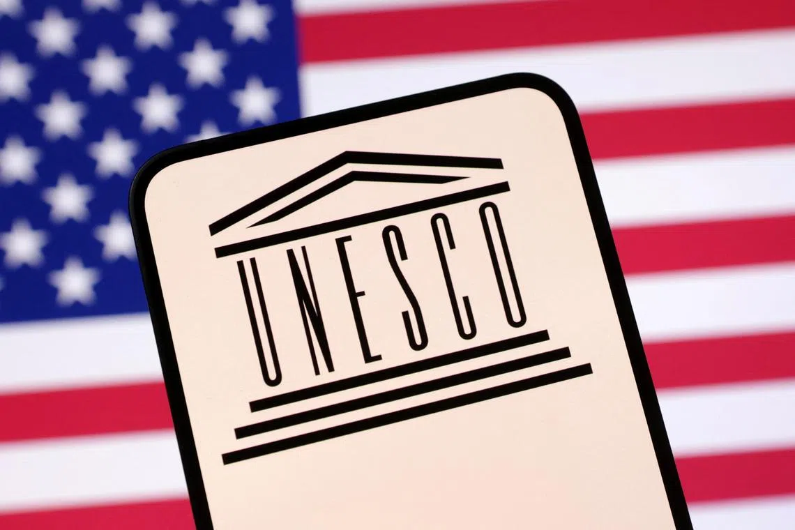 UNESCO logo and U.S. flag are seen in this illustration taken April 23, 2025. REUTERS/Dado Ruvic/Illustration
