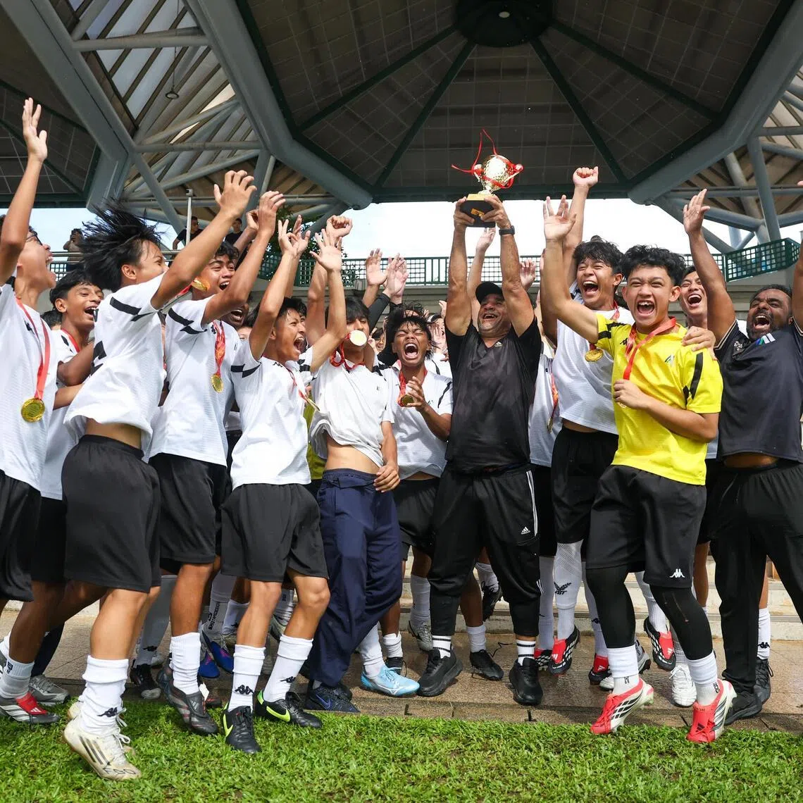 Meridian Secondary School players and coach celebrating after winning the National School Games B Division boys' football final at the Serangoon Stadium on May 12.