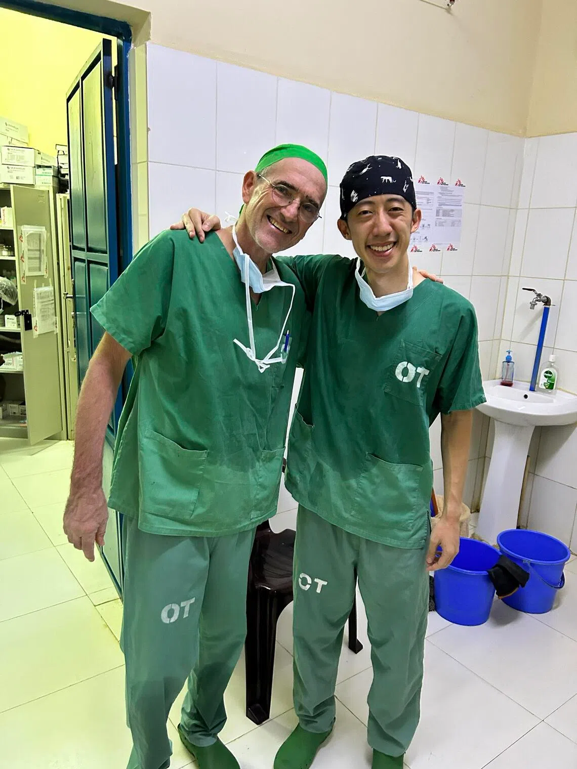 Tan Tock Seng Hospital specialist trauma surgeon Tang Jun Han with German general surgeon Matthias Oppelt in Abyei.