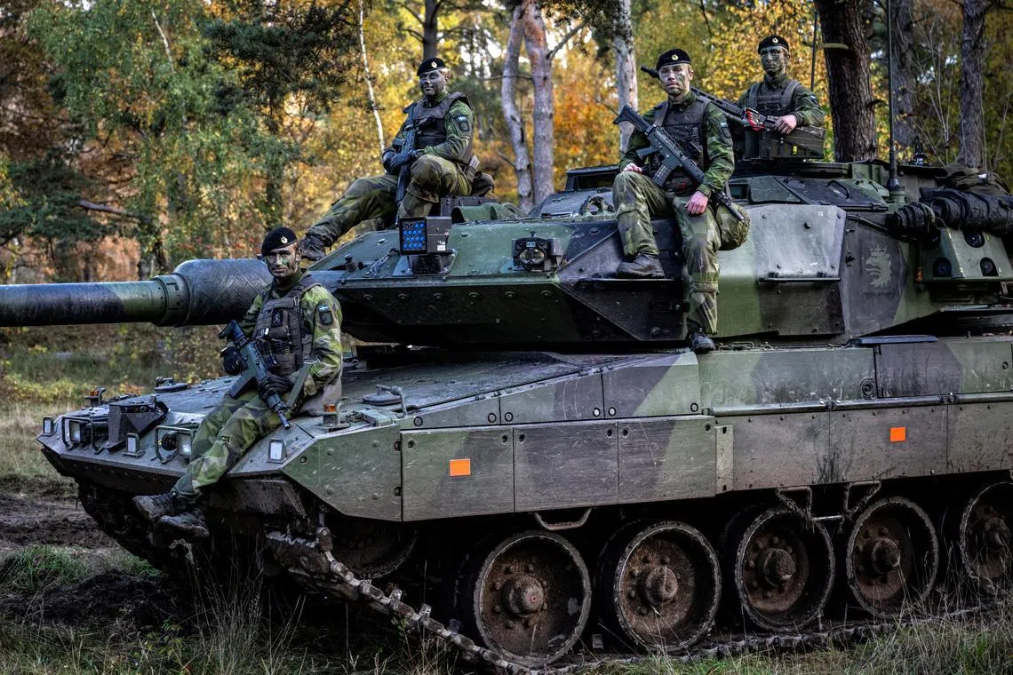 Soldiers sit on a tank at P7 Regiment in Revingehed, Sweden October 24 2024. TT News Agency/Johan Nilsson via REUTERS