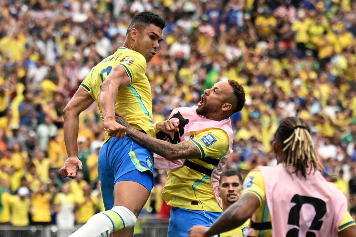 Brazil’s Casemiro celebrates with Neymar after scoring against Japan at the World Cup.