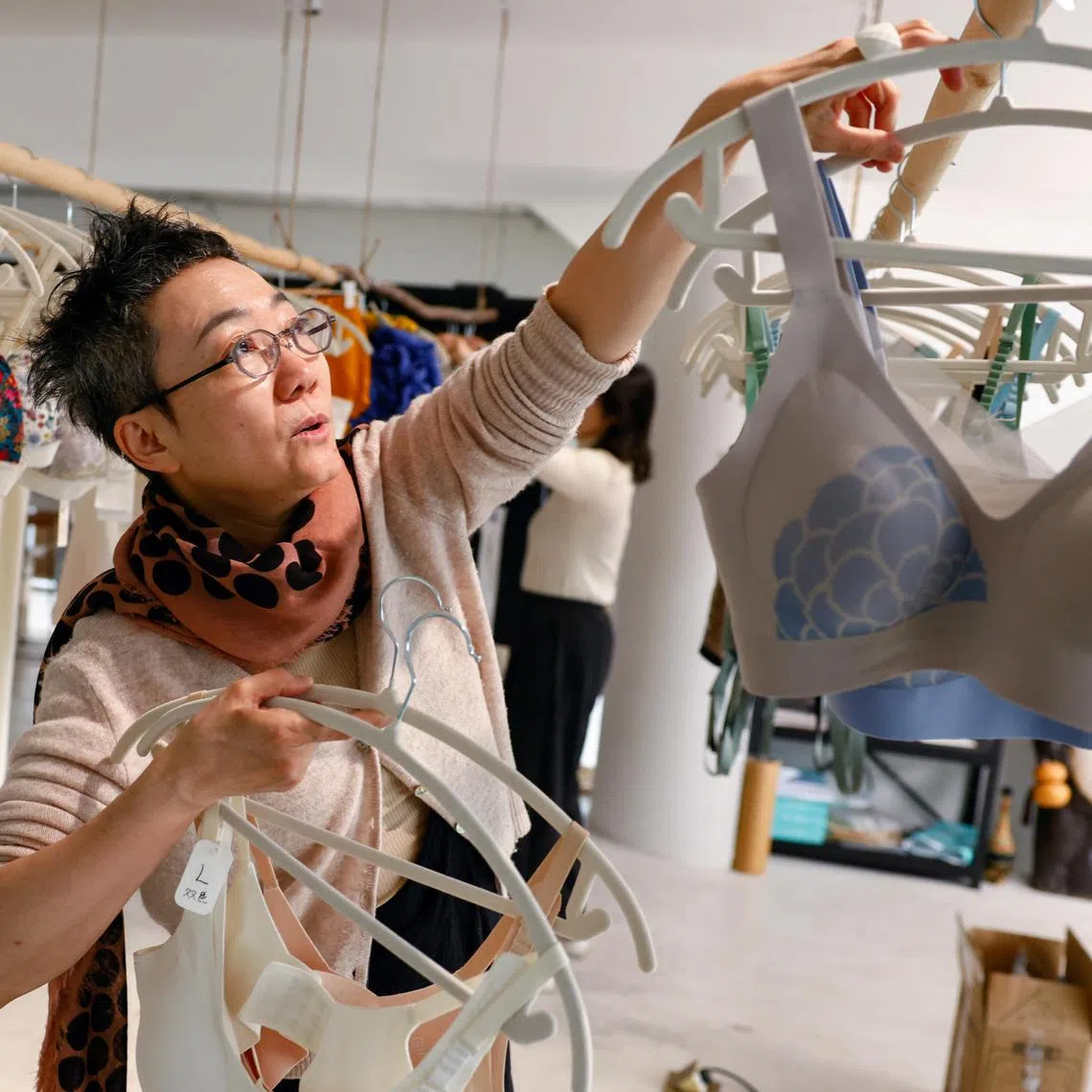 Emily Yu, a designer who founded Ginger Ah, a lingerie brand for women with breast cancer, introduces her bra products at her studio in Beijing, China on March 3, 2025. 