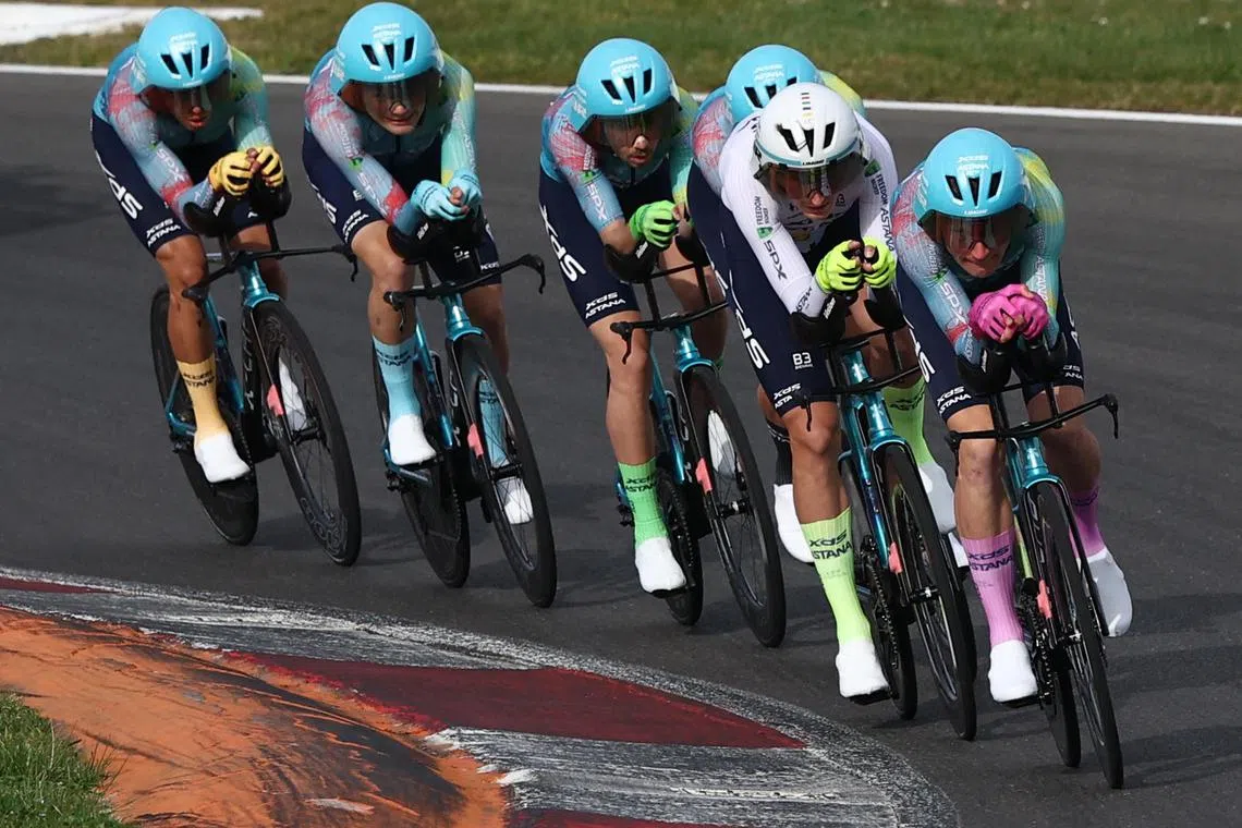 XDS Astana Team's riders in different coloured socks and gloves in the third stage of the Paris-Nice cycling race, a 28.4 km team time trial between Nevers Magny-Cours Circuit and Nevers, on March 11, 2025.