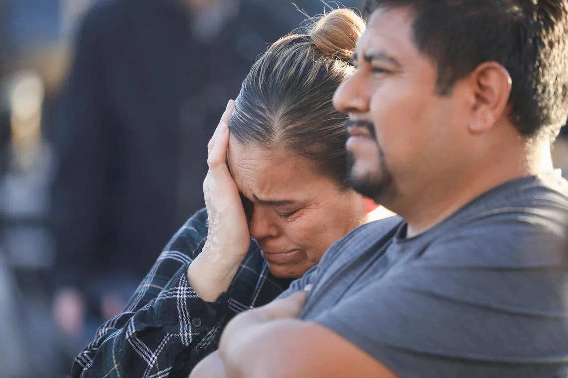 People mourn outside the entrance of the Star Ballroom Dance Studio after a mass shooting during Chinese Lunar New Year celebrations in Monterey Park, California, U.S. on  Jan 23, 2023. 