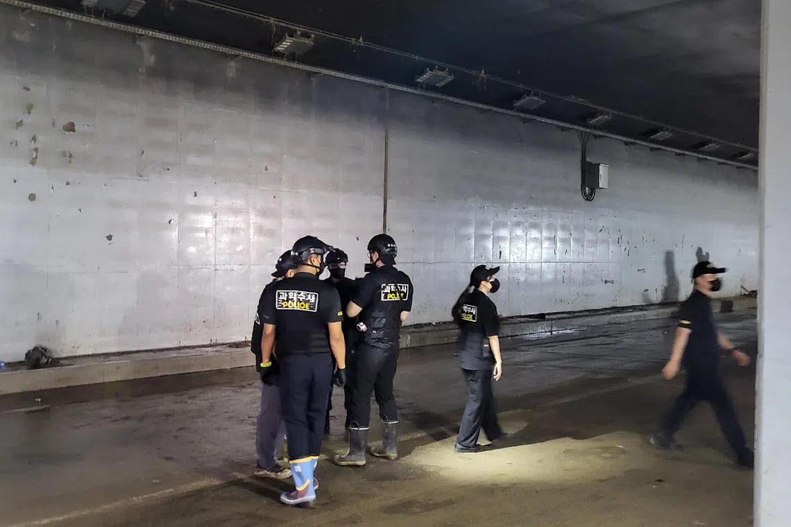 epa10756670 Police investigators examine an underground roadway in the town of Osong, Cheongju, South Korea, 20 July 2023, where 14 people were killed following the overflowing of a nearby river triggered by torrential rain on July 15.  EPA-EFE/YONHAP SOUTH KOREA OUT