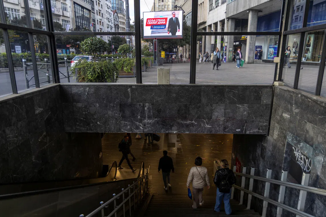 People walk in the underpass past an electoral poster of Serbia's former President and the ruling Serbian Progressive Party (SNS) candidate for Prime Minister Aleksandar Vucic in Belgrade, Serbia, October 16, 2026. REUTERS/Djordje Kojadinovic