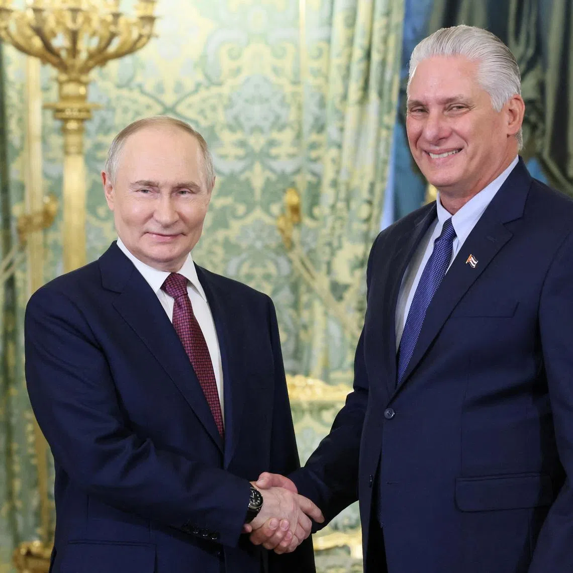Russian President Vladimir Putin shakes hands with Cuban President Miguel Diaz-Canel during a meeting at the Kremlin in Moscow, Russia, May 7, 2025. Sputnik/Mikhail Metzel/Pool via REUTERS