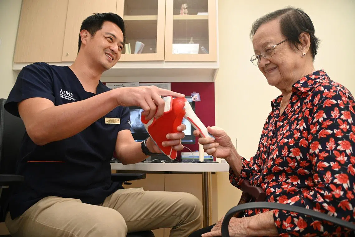 Mrs Babe Lim (right), 94, speaking with orthopaedic surgeon Kevin Yik. Mrs Lim is one of a growing number of seniors going under the knife.