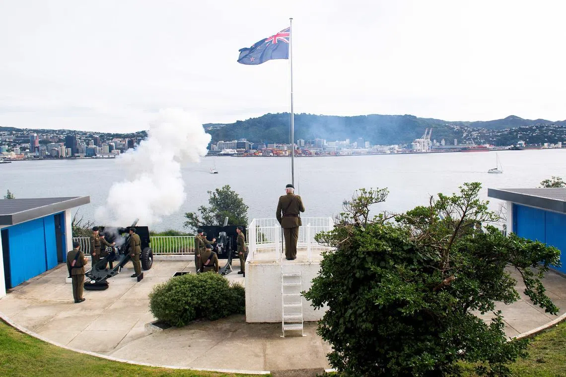 This handout photo released by the New Zealand Defence Force on  Sunday shows New Zealand army personnel firing a 21-gun salute in Wellington to commemorate the coronation of King Charles. 