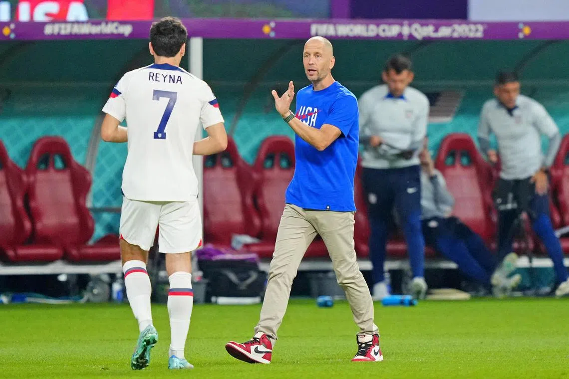 Gregg Berhalter talking to midfielder Giovanni Reyna during the World Cup match between the United States and the Netherlands at the Qatar World Cup.