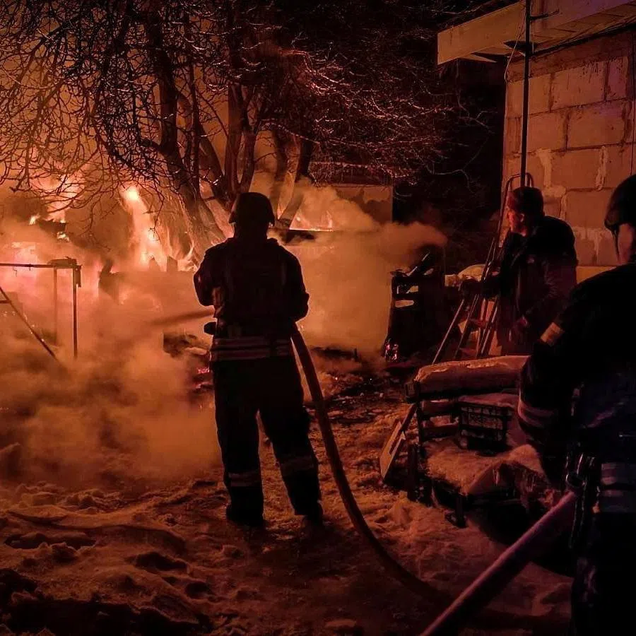 Firefighters work at the site of a residential household damaged during Russian drone and missile strikes, amid Russia's attack on Ukraine, in Kyiv region, Ukraine, January 13, 2026. Press service of the State Emergency Service of Ukraine in Kyiv region/Handout via REUTERS