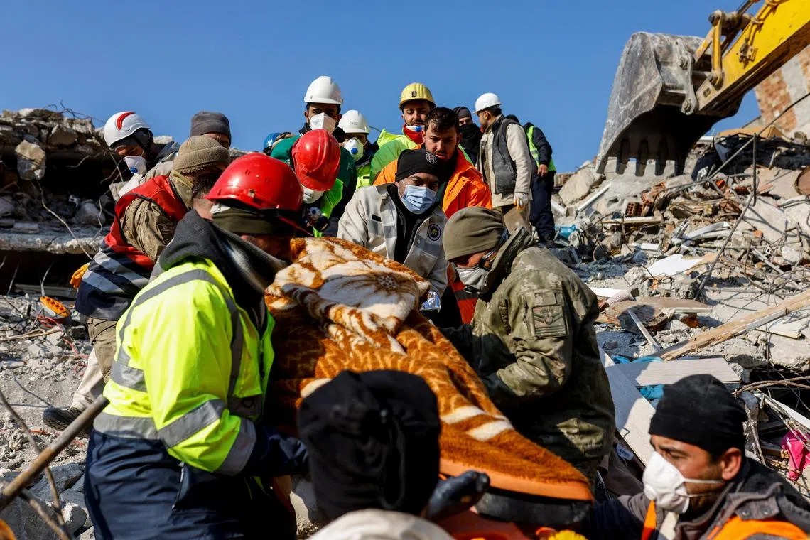 Rescuers carry survivor Muzeyyen Ofkeli in the aftermath of a deadly earthquake, in Hatay, Turkey February 12, 2023. REUTERS/Kemal Aslan