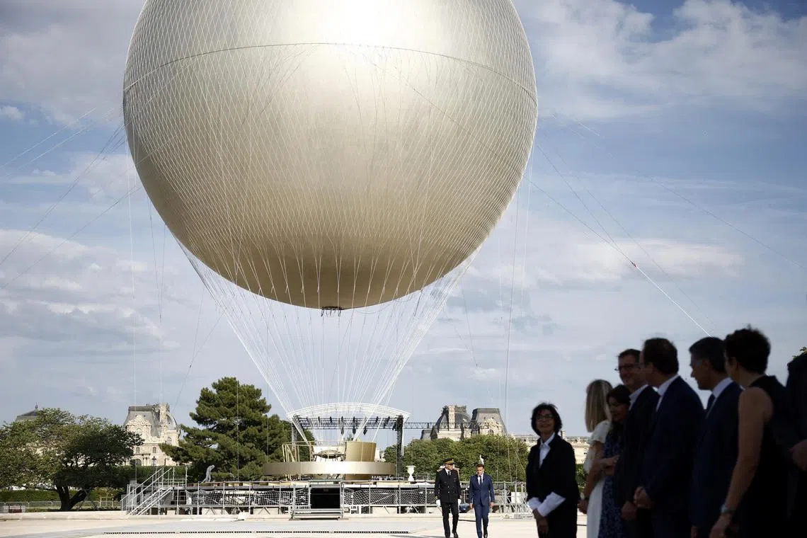 French President Emmanuel Macron visits the site of the reinstallation of the Olympic cauldron at the Tuileries Garden in Paris.