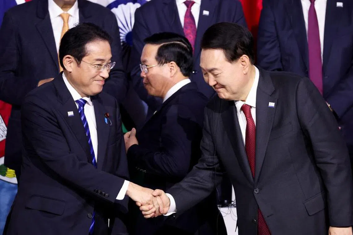 FILE PHOTO: Japan's Prime Minister Fumio Kishida shakes hands with South Korea's President Yoon Suk Yeol as they attend the Indo-Pacific Economic Framework (IPEF) Leaders event at the Asia-Pacific Economic Cooperation (APEC) CEO Summit in San Francisco, California, U.S. November 16, 2023. REUTERS/Brittany Hosea-Small/FILE PHOTO