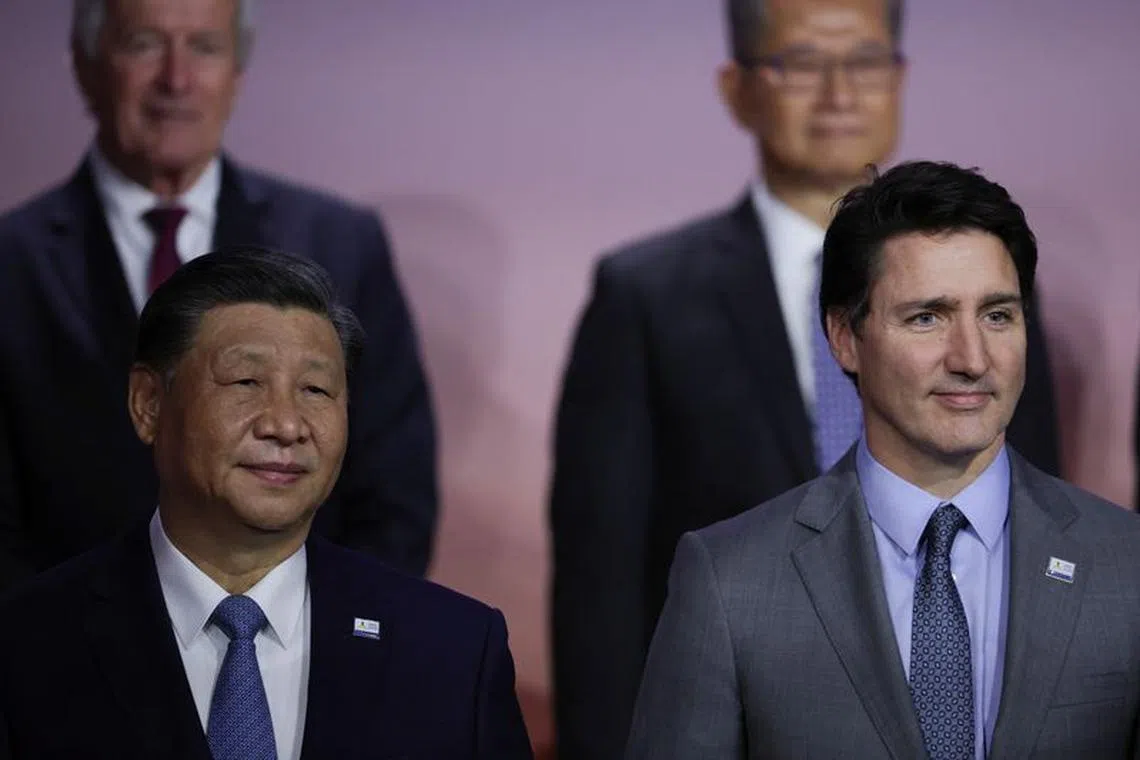 Chinese President Xi Jinping and Canada's Prime Minister Justin Trudeau pose for a family photo during Asia-Pacific Economic Cooperation (APEC) CEO Summit in San Francisco, California, U.S. November 16, 2023. REUTERS/Carlos Barria