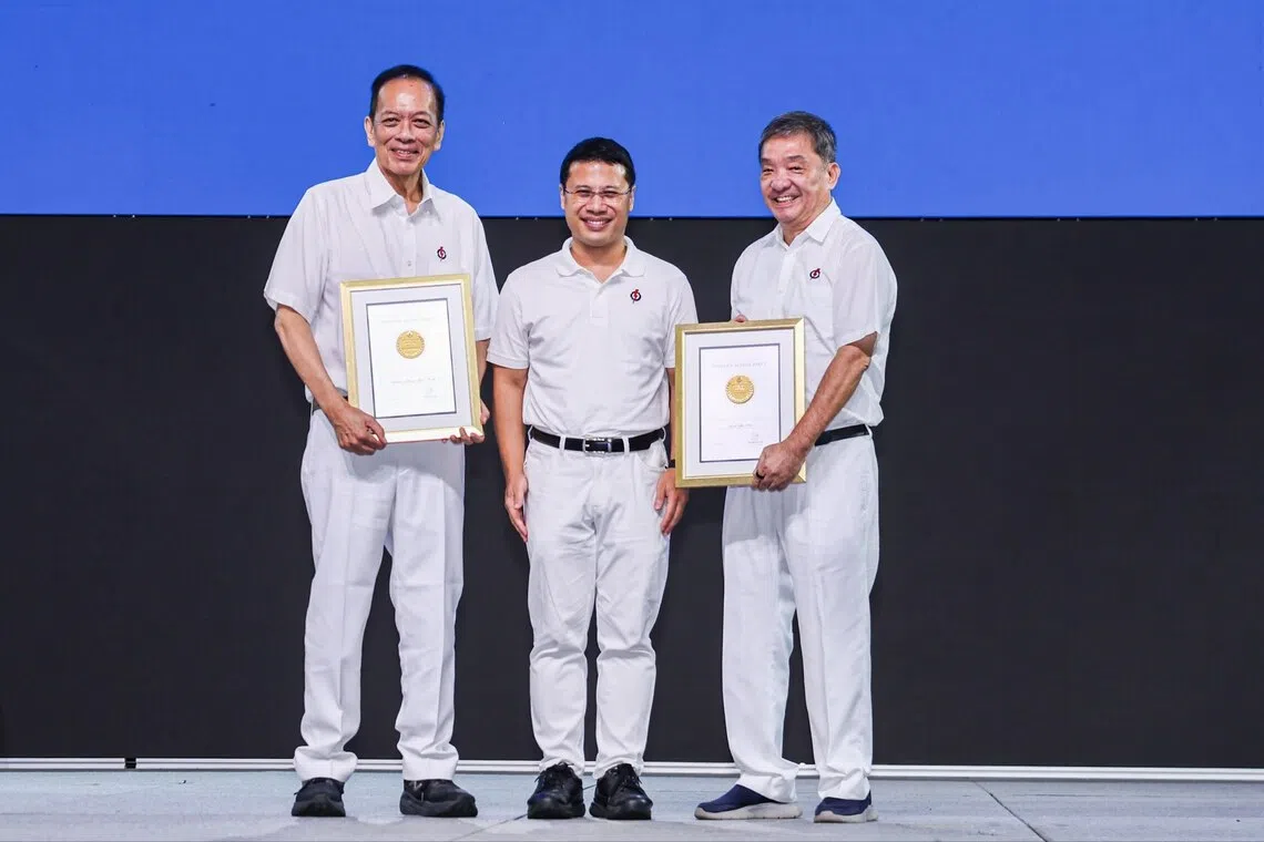 PAP members Charles Chong (left) and Sitoh Yih Pin (right) receiving the meritorious service medals from party chair Desmond Lee (centre) during the PAP Awards and Conference at Singapore Expo, on Oct 25.