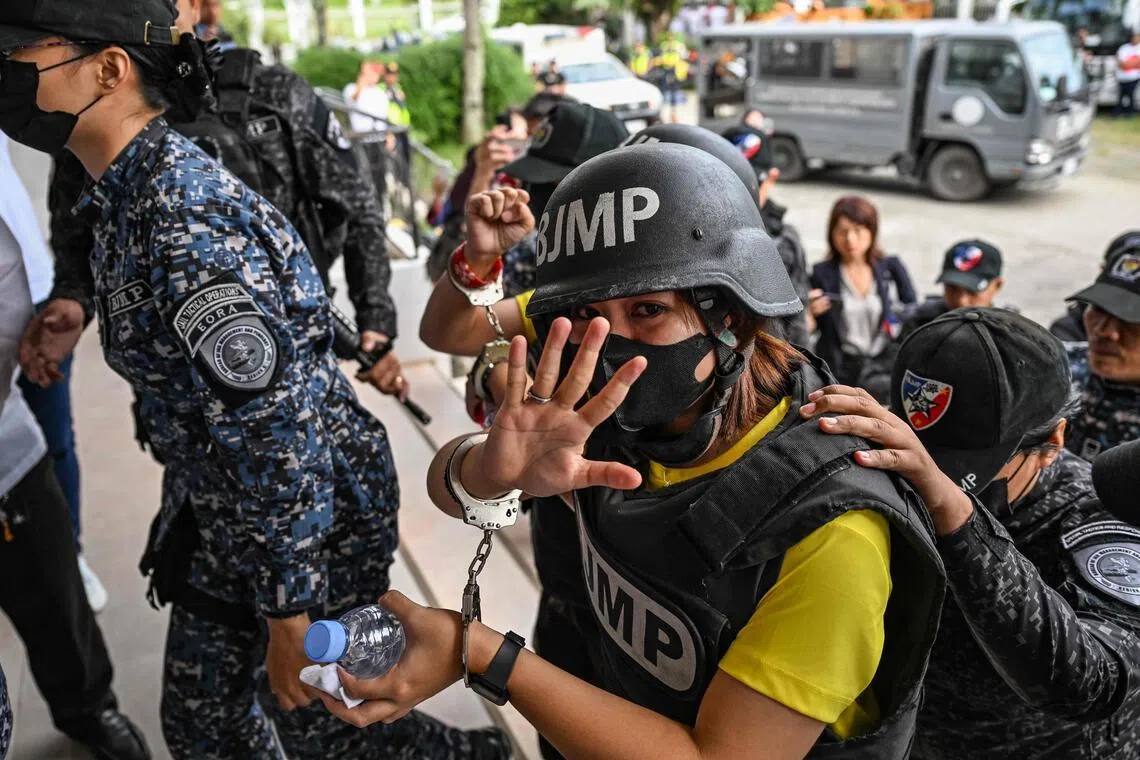 Frenchie Mae Cumpio, a detained Filipino journalist, gestures as she arrives at Tacloban Regional Trial Court in Leyte island on Jan 22 to attend the promulgation of her court case.