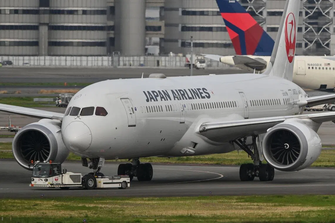 A Japan Airlines (JAL) passenger plane being towed along a runway at Tokyo International Airport at Haneda on April 11.