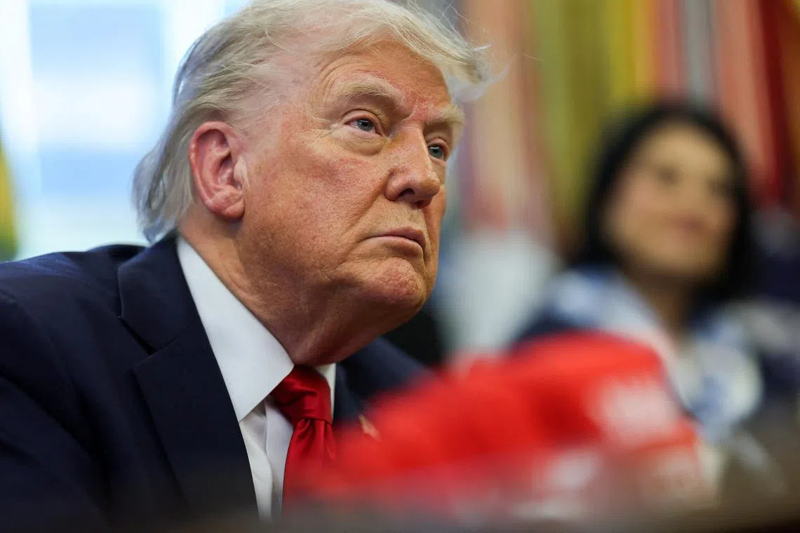 FILE PHOTO: U.S. President Donald Trump looks on, as he signs executive orders in the Oval Office at the White House in Washington, D.C., U.S., April 23, 2025. REUTERS/Leah Millis/File Photo