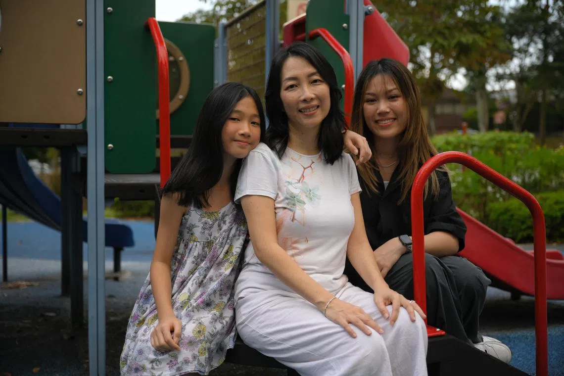 Ms Michelle Choy (centre) with her daughters Elizabeth Wee (right), 23, and Victoria Wee, 11.