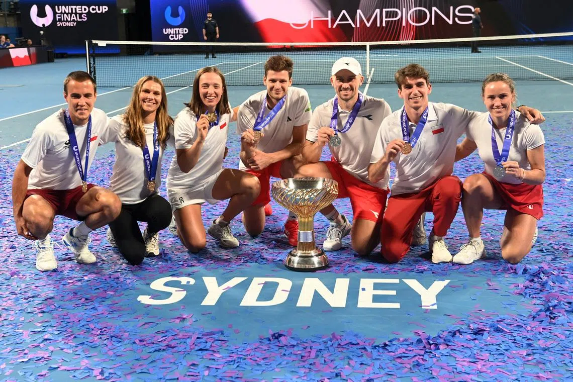 Tennis - United Cup - Final - Poland v Switzerland - Ken Rosewall Arena, Sydney, Australia - January 12, 2026 Poland players celebrate with the trophy after winning the United Cup REUTERS/Jeremy Piper