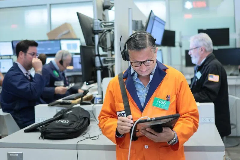 Traders work on the floor of the New York Stock Exchange during morning trading on June 15, 2026 in New York City. 
