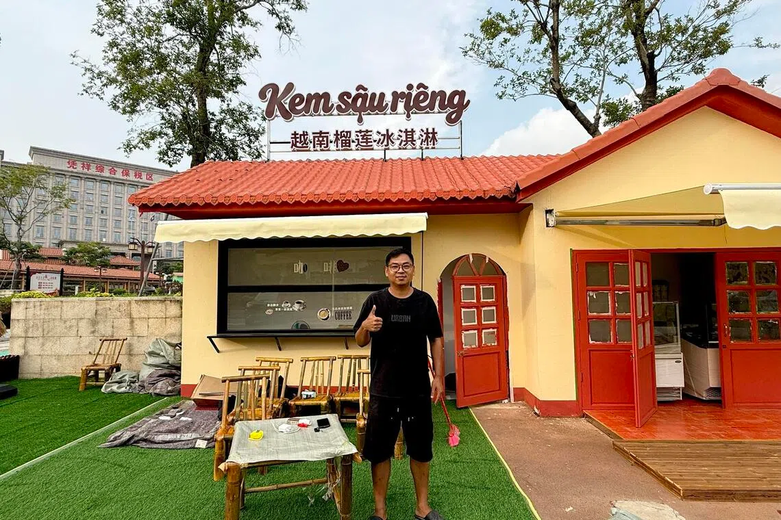 Lee Ni readying his durian ice cream cafe for opening near the Friendship Pass scenic area in Pingxiang, China.