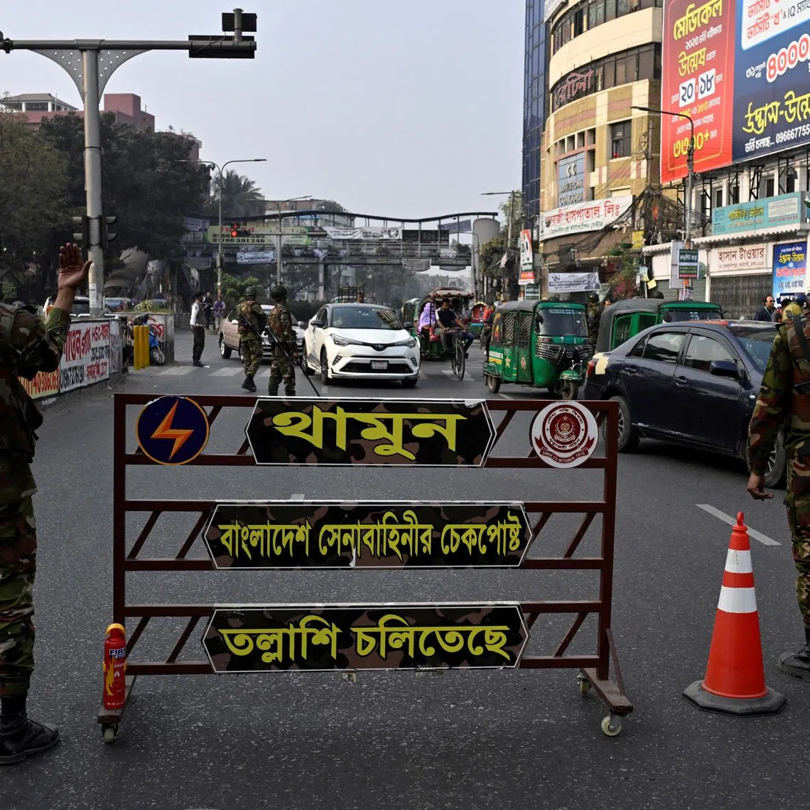 Members of the Bangladesh Army direct traffic at a temporary checkpoint in Dhaka, Bangladesh, February 11, 2026. REUTERS/Fatima Tuj Johora
