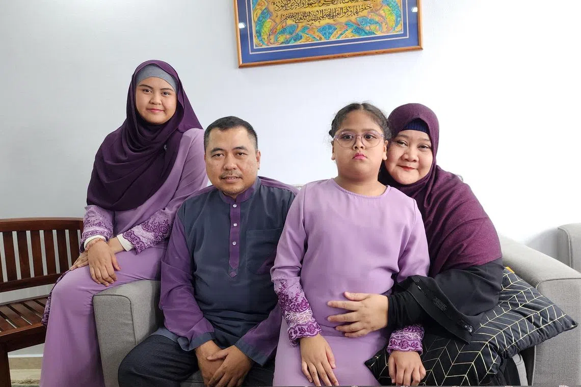 ST20230522_202331390041: Gin Tay / etaward22/ Elisha Tushara/ *EMBARGOED UNTIL 22 MAY 2023 at 5.00 PM* (Pls credit Mdm Salinah Binte Parsiri )
From right: Mdm Salinah Binte Parsiri, 48, with her adopted daughter Anis Humairah Binte Muchamed Elfian, 10, husband Muchamed Elfian Bin Harun, 48 and daughter Anis Amiera Binte Muchamed Elfian, 21.
Mdm Salinah Binte Parsiri 48, recipient of the Inspirational Caregiver Award at the Singapore Health Inspirational Patient and Caregiver Awards 2023 on May 22, 2023.