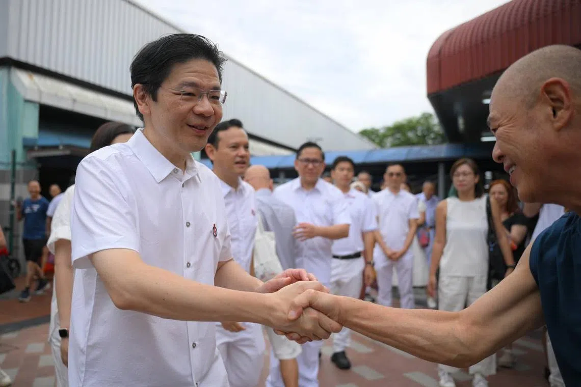 Prime Minister Lawrence Wong, alongside his fellow MPs, thank residents around the Marsiling Market on May 5.