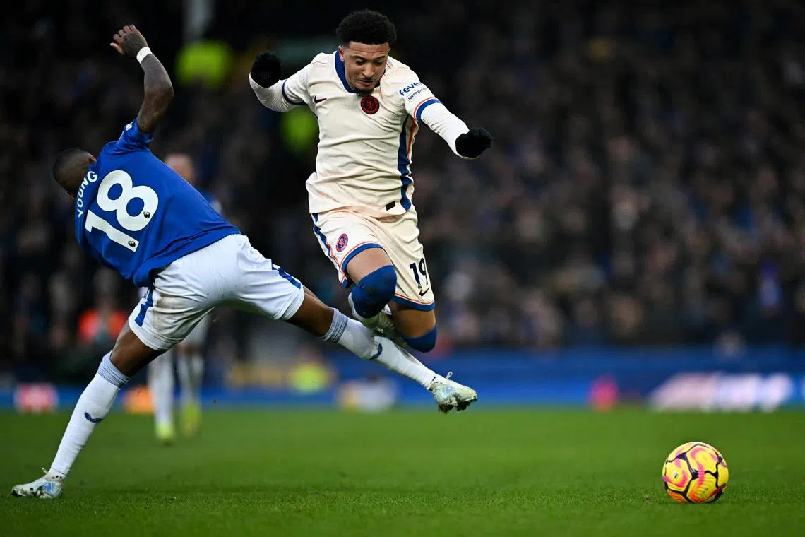 Everton defender Ashley Young (left) fights for the ball with Chelsea midfielder Jadon Sancho.